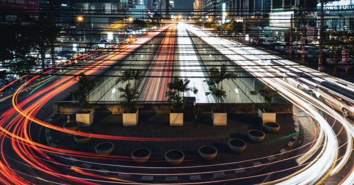 Long-exposure traffic light trails through a city at night